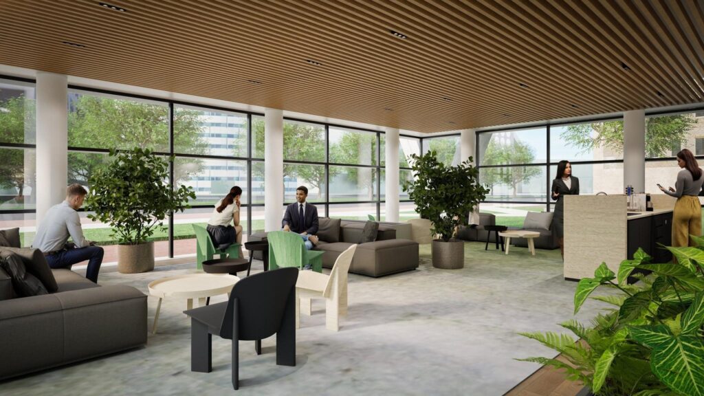 Modern office lobby with people sitting, talking, and getting coffee in a spacious, light-filled area with large windows and indoor plants.
